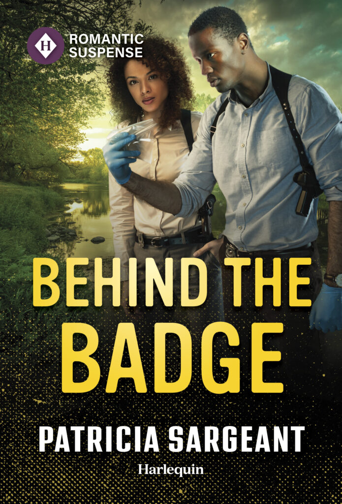 Cover of Behind the Badge: Justice Hunters, Book 1 by Patricia Sargeant. African American man special agent on the right. African American woman detective on the left. Standing in a lush, green park near the water, studying evidence from the crime scene.